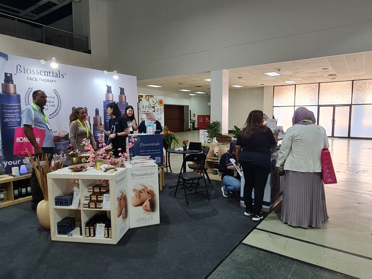 Biossentials team speaking with visitors at a professional spa and beauty exhibition